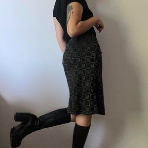 Pony Tail figure hugging black midi skirt with silver geometric print